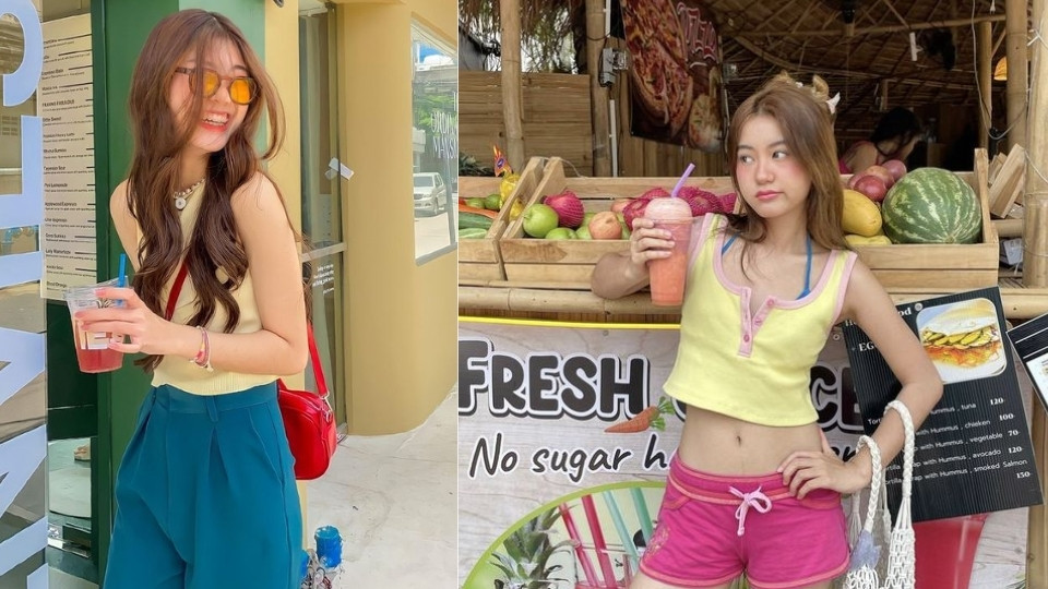 Cô gái trẻ tạo dáng cầm ly trà sữa trân châu và nghiêng đầu nhẹ nhàng, chuẩn bị chụp ảnh đẹp