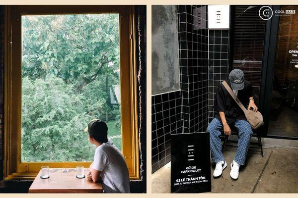 Một người đang tạo dáng giấu mặt với ly trà sữa, tạo nên bức ảnh sống ảo đầy bí ẩn và thu hút tại quán cafe.